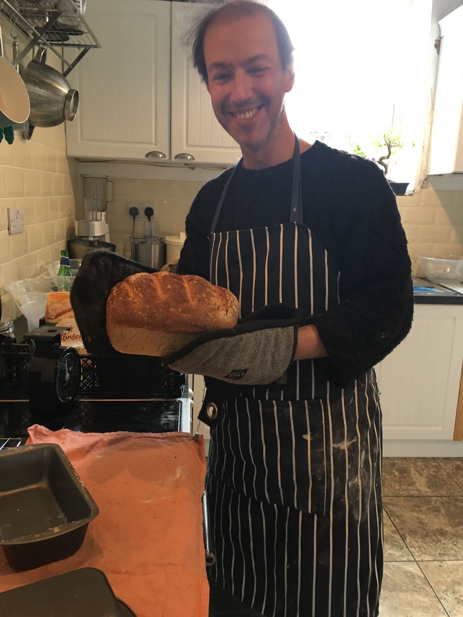 Philip getting bread out of the oven